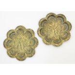 19thC Indian brass plates: a pair of 8 lobed plates each having a Indian deity to centre,