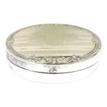 A late 19thC / early 20thC german / nickel silver snuff box with of oval form with engraved