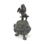 An 18th / 19thC cast bronze censer with three feather footed legs and mask decoration,