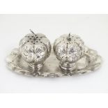 Mexican silver cruet set comprising salt and pepper shakers of gourd form having engraved