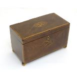 An 18thC Sheraton inlaid flame mahogany two division tea caddy, with turned spherical feet.