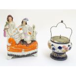 A 19thC Staffordshire flatback figural group of a man with a musical instrument and a woman with a