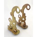 A pair of 19thC phosphor bronze wall hooks/curtain rails each having two circular piercings and