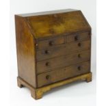 A late 18thC mahogany bureau with a fall front above two short and three long drawers with turned