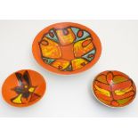 Three items of orange ground Poole pottery, to include a large bowl (shape no.