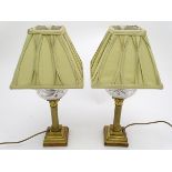 Table lamps: a pair of converted oil peg lamps having gilded Corinthian bases with square stepped
