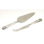A silver handled cheese knife together with a silver handled pie server.