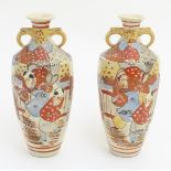A pair of Imari style vases with decorative twin handles,