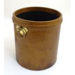 A leather cylindrical shaped waste paper bin with brass fitments,