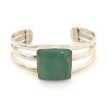 A silver bangle bracelet set with large aventurine squared cabochon to centre.