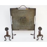 Arts and Crafts: a wrought iron and brass (beaten) firescreen and 2 fire dogs exhibiting relief