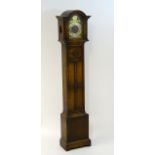 Oak grandmother clock: A musical sprung 3 train 7 3/4" breakdial floor standing clock,