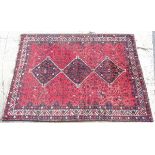 Rug / Carpet: A hand made Persian woolen carpet with wine red ground,