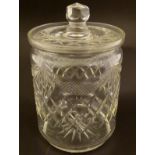 Glass: an early 20thC cut glass lidded biscuit jar with swag and hobnail decoration,