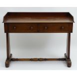 A mid 19thC mahogany wash stand with a shaped up stand above two short frieze drawers and raised on