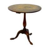 A 19thC country tripod table with a circular mahogany top above a turned tapering stem and a tripod