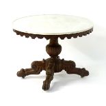 A mid 19thC mahogany marble topped oval table with a shaped frieze,
