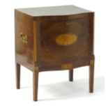 A mahogany George III cellarette with a serpentine shaped front,