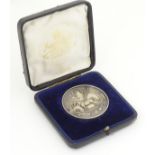 A cased silver medallion depicting horse, horseshoe and leeks, titled ' Welsh Pony and Cob Society.