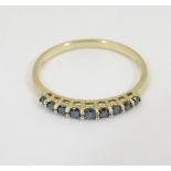 A 10k gold ring set 9 graduated tanzanite? blue? coloured stones CONDITION: Please