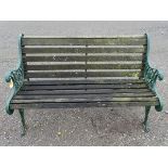 Garden bench: a teak and green painted cast iron 2 seat bench, measuring 49 1/2” wide.
