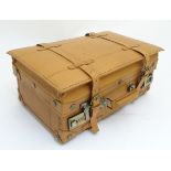 A pig skin expandable case with a combination lock and brass fitments,