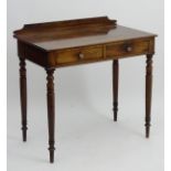 A mid 19thC mahogany side table with a shaped up stand and rectangular top above two short drawers