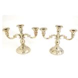 A pair of Continental silver candelabra marked .835 . Approx 9" high x 11" wide overall.