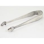 Geo III silver sugar tongs with bright cut decoration and acorn formed grips. With incuse duty mark.