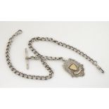 A hallmarked silver curblink pocket watch chain, with T-bar and fob,
