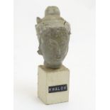 An East Asian ceramic head mounted on a square stone plinth labelled 'Khalok', 5 1/4" high.