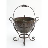 Arts and Crafts: A wrought iron and copper swing handled fireside planter / log basket,