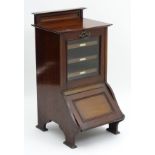 An early 20thC mahogany music cabinet purdonium,