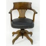 A late 19thC / early 20thC oak adjustable captains chair with a curved backrest and Chippendale