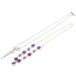 A silver necklace set with facet cut amethysts together with a silver necklace with butterfly