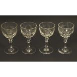 Georgian glasses: a set of four facet cut pedestal glasses with ground pontil scars under,