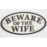 A 21stC painted cast metal oval sign, 'beware of the wife',