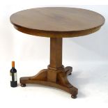 A mid / late 19thC mahogany tilt top table with a triform base raised on bun feet.