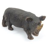 A carved wooden model of a rhino CONDITION: Please Note - we do not make reference