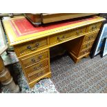 A late 20thC yew pedestal desk with red leather insert CONDITION: Please Note - we