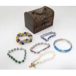 A small jewellery box containing an assortment of bracelets CONDITION: Please Note -