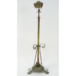 An Arts & Crafts brass and copper height-adjustable standard lamp,