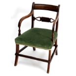 A Regency mahogany open armchair with a reeded curved top rail and having shaped arms with turned