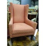 An upholstered Edwardian wingback armchair CONDITION: Please Note - we do not make