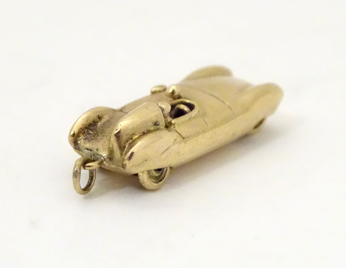 A gold vintage pendant / charm formed as an early racing car 1 1/8" long CONDITION: - Image 8 of 9