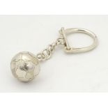 A silver and silver plate key ring with football fob.