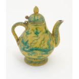 A Chinese yellow ground small proportion lidded wine ewer decorated with green stylised dragons and
