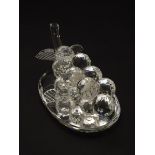 A Swarovski-style crystal table decoration in the form of a grape cluster, with mirrored base,