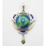 An Arts & Crafts silver pendant with hammered and enamel decoration.
