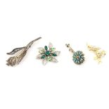 4 brooches : A silver brooch of floral form with filigree decoration,